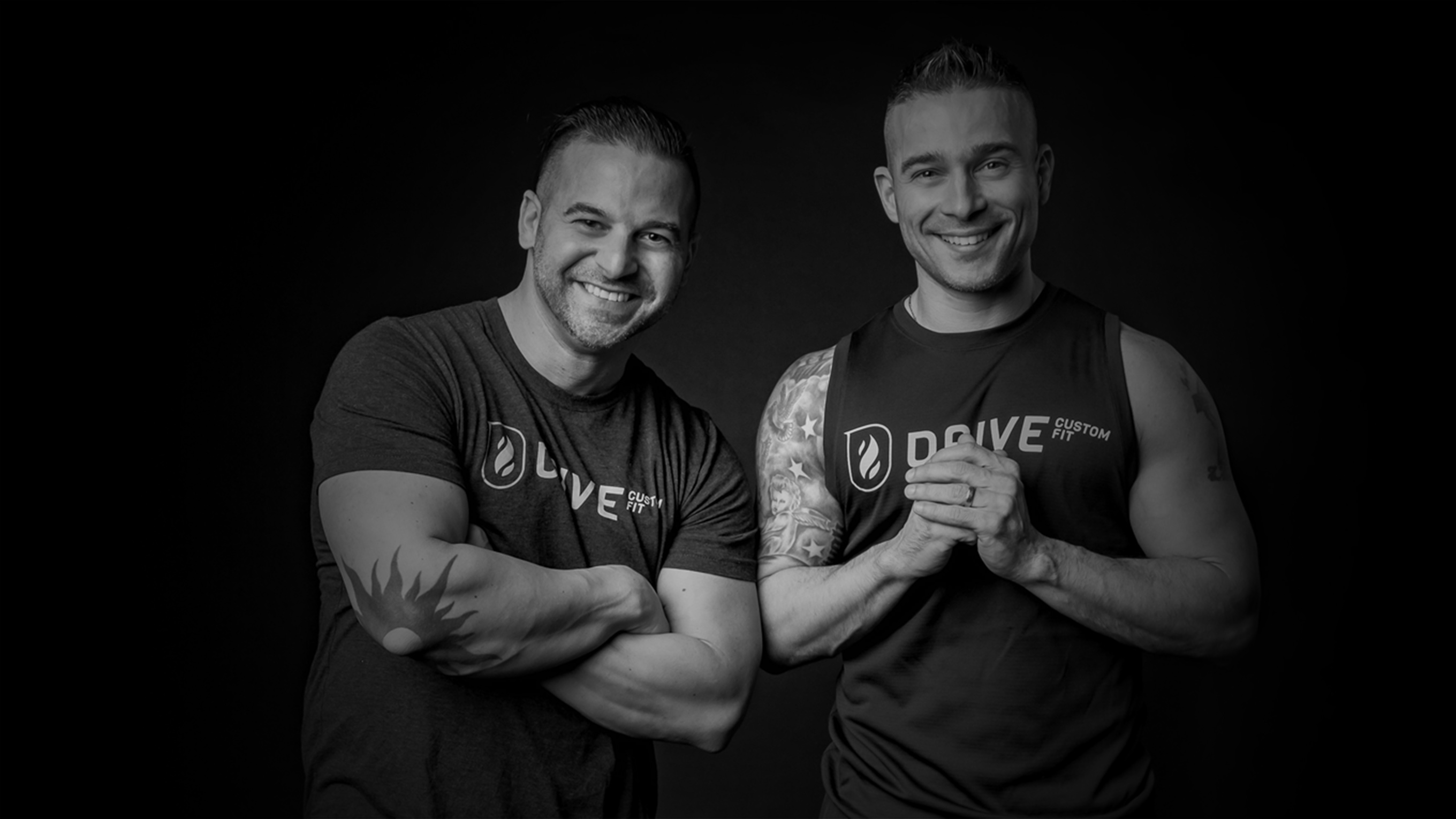 Two men smiling in Drive Custom Fit shirts